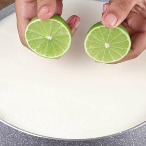 Pour the lemon into the boiling milk. Easy recipe with only 2 ingredients.